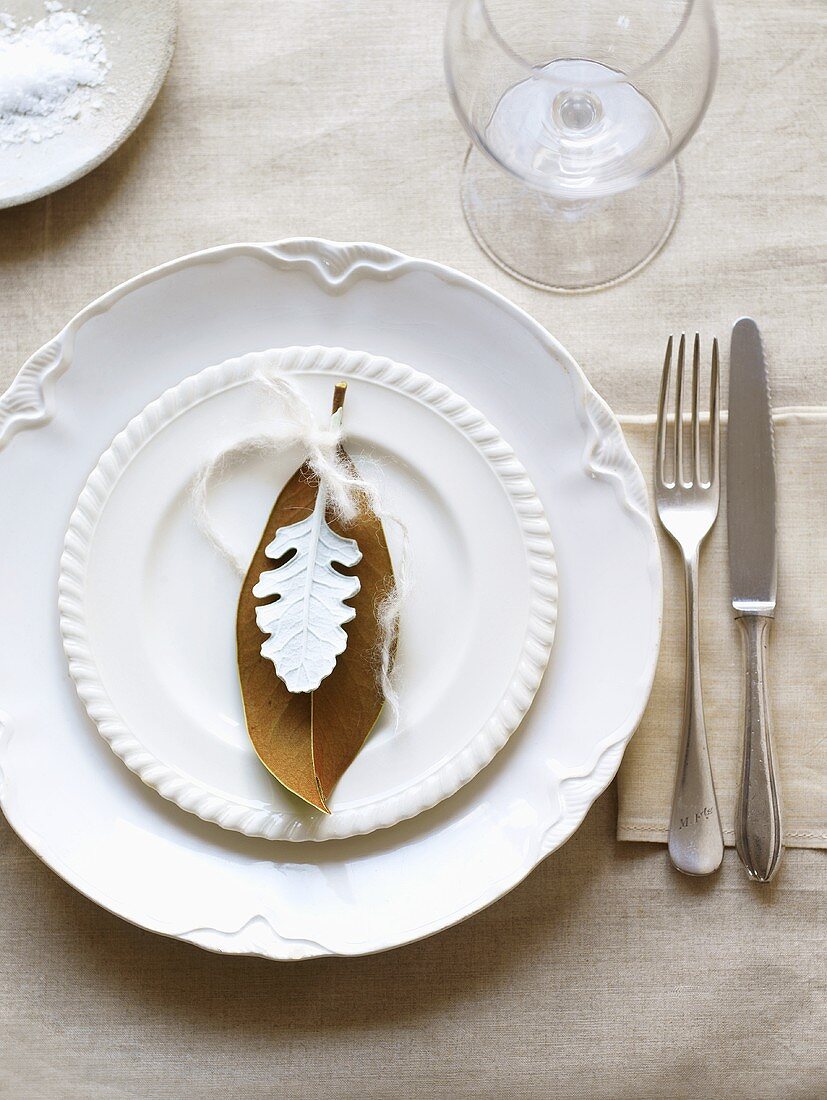 White place-setting with leaves