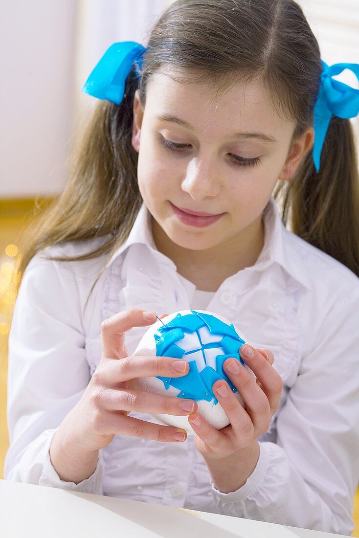 Girl making a Christmas bauble