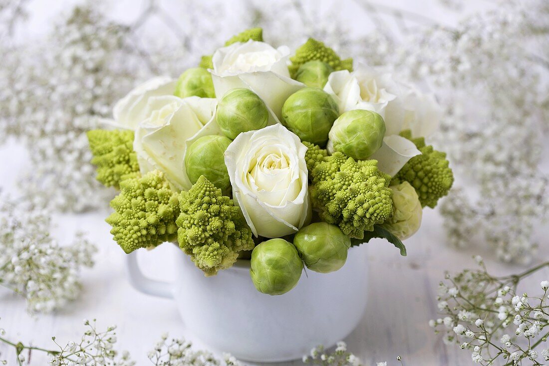 Winter arrangement of white roses, romanesco & Brussels sprouts