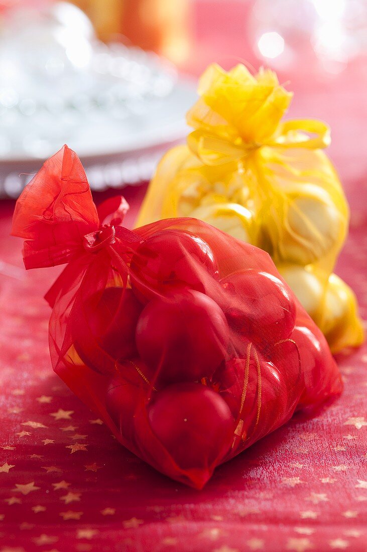 Red and yellow sacks of Christmas baubles