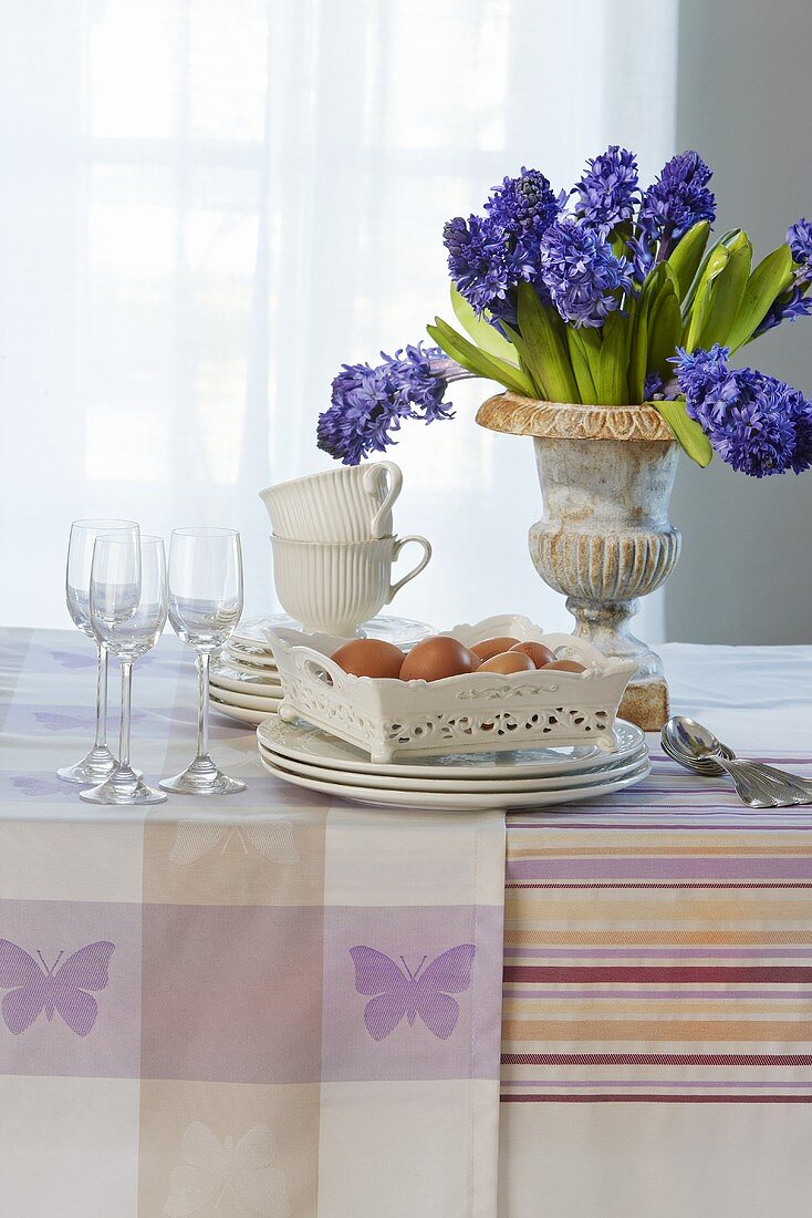 Crockery, eggs and blue hyacinths on a table