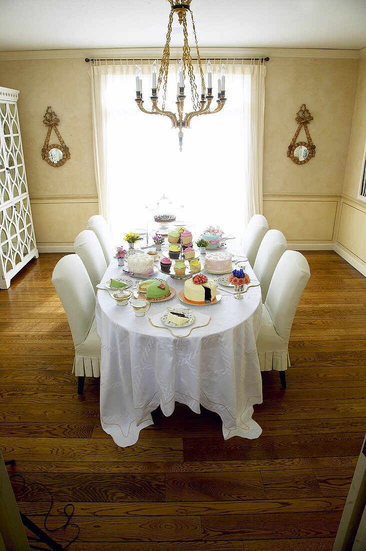Dining Table Set with Many Assorted Cakes; In Dining Room