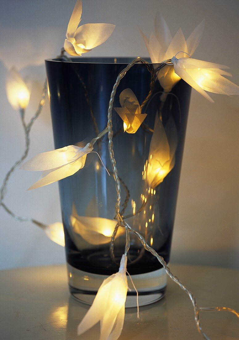 A vase decoarted with fairy lights