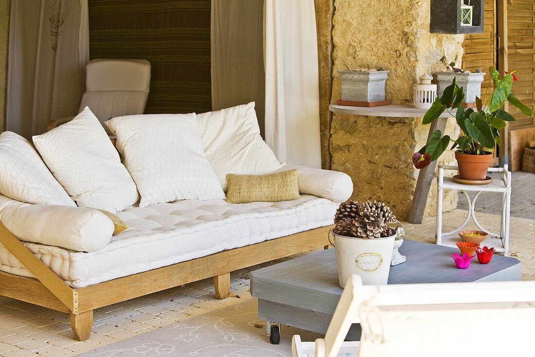 White sofa cushions on a wooden frame in a country house