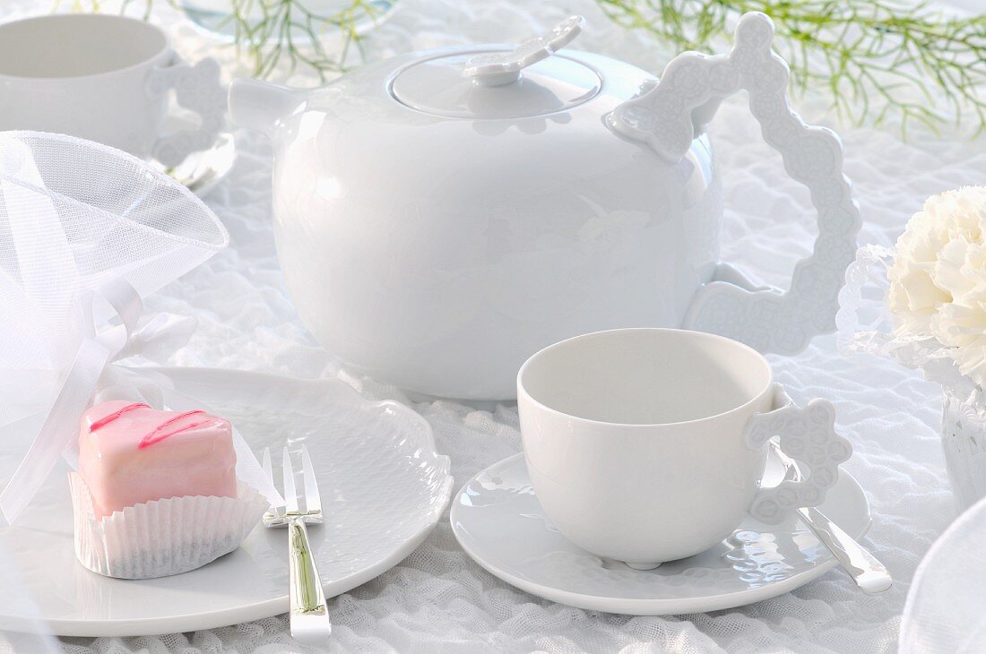 Rosa Desserttörtchen auf weißem Geschirr mit festlicher Deko