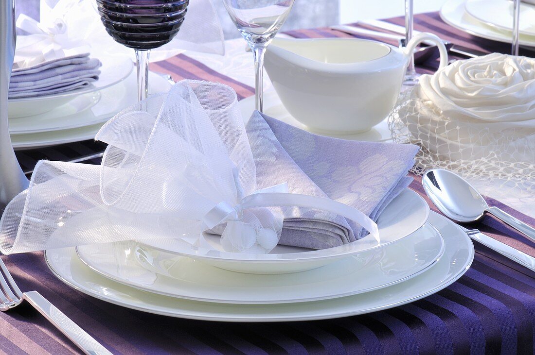 A festively decorated place setting with packets of sweets