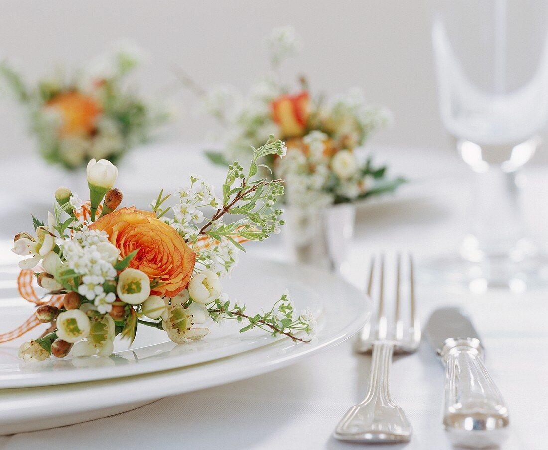 A flower arrangement on a white plate