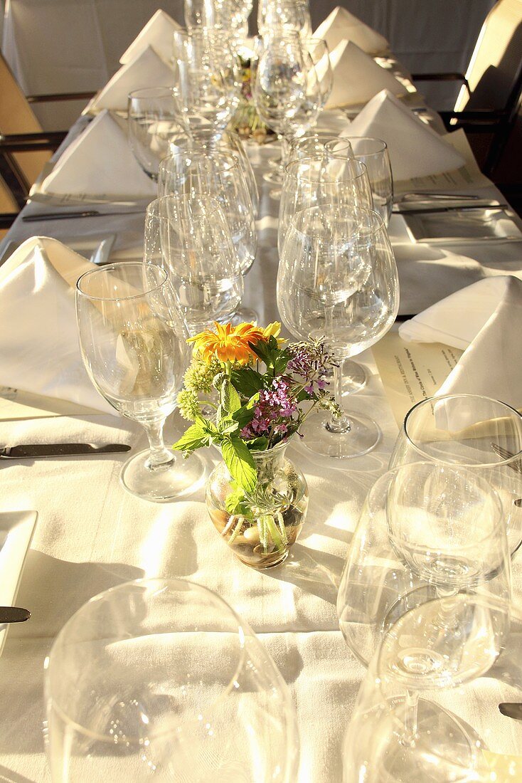 A festively laid table with empty wine glasses