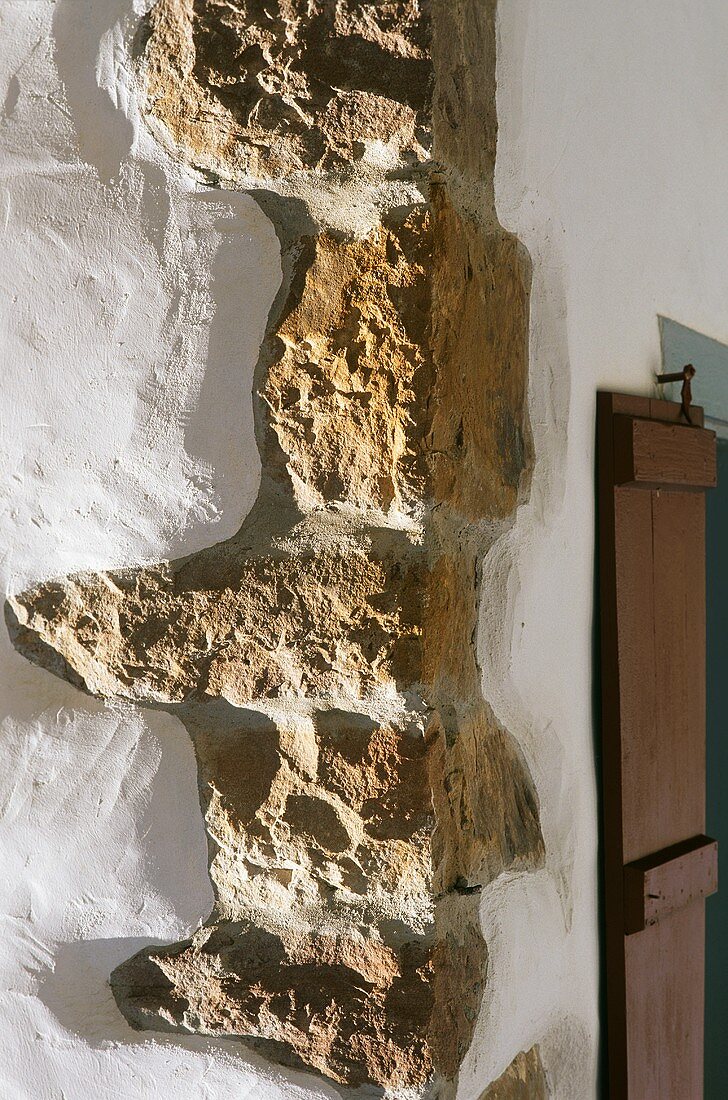A brick wall with and without plaster
