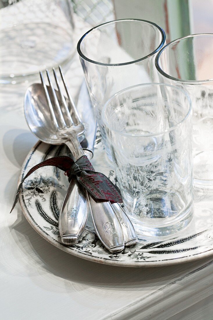 Glasses and silver cutlery on a plate