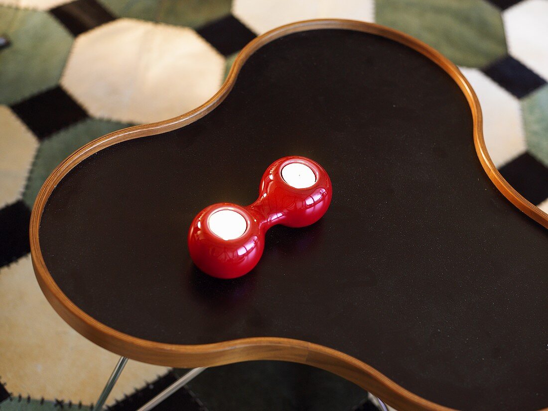 Tea lights in a red ceramic candle holders on a side table
