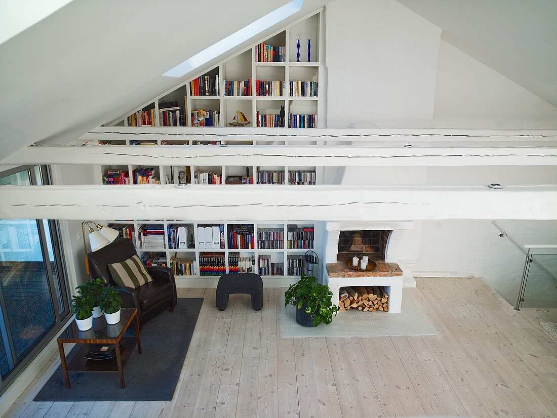 View into a living room with bookshelves in a niche under a ceiling
