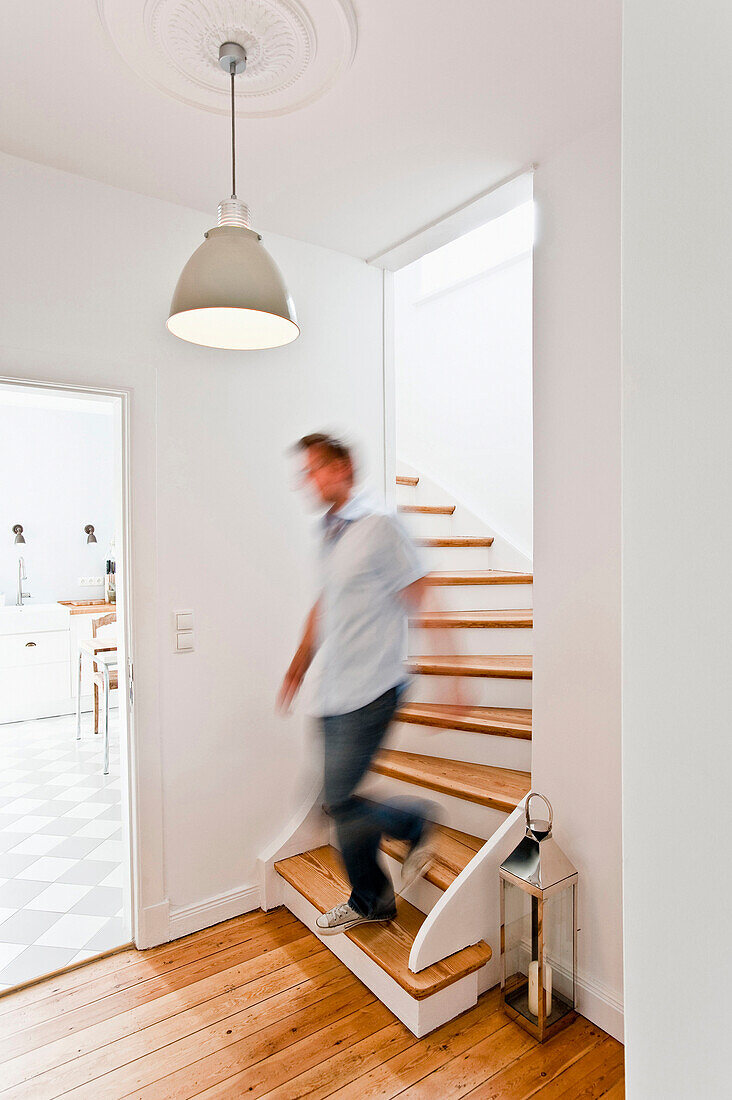 Man walking down the stairs, House furnished in country style, Hamburg, Germany