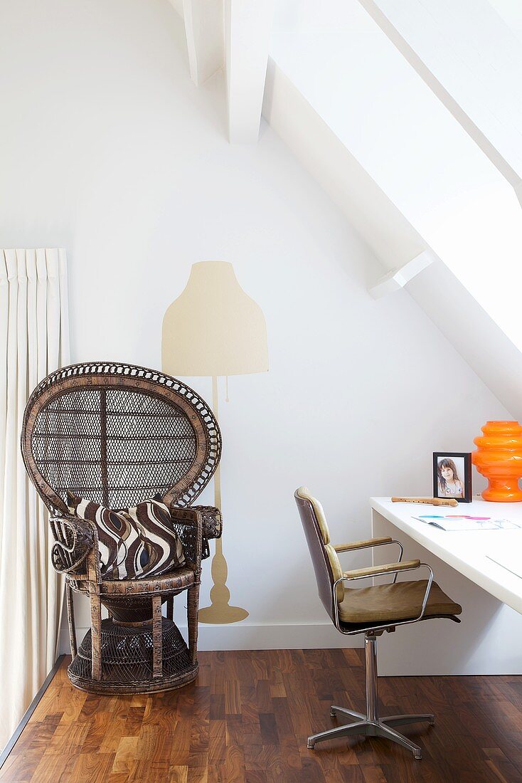An African-style wicker chair in a white-painted attic room