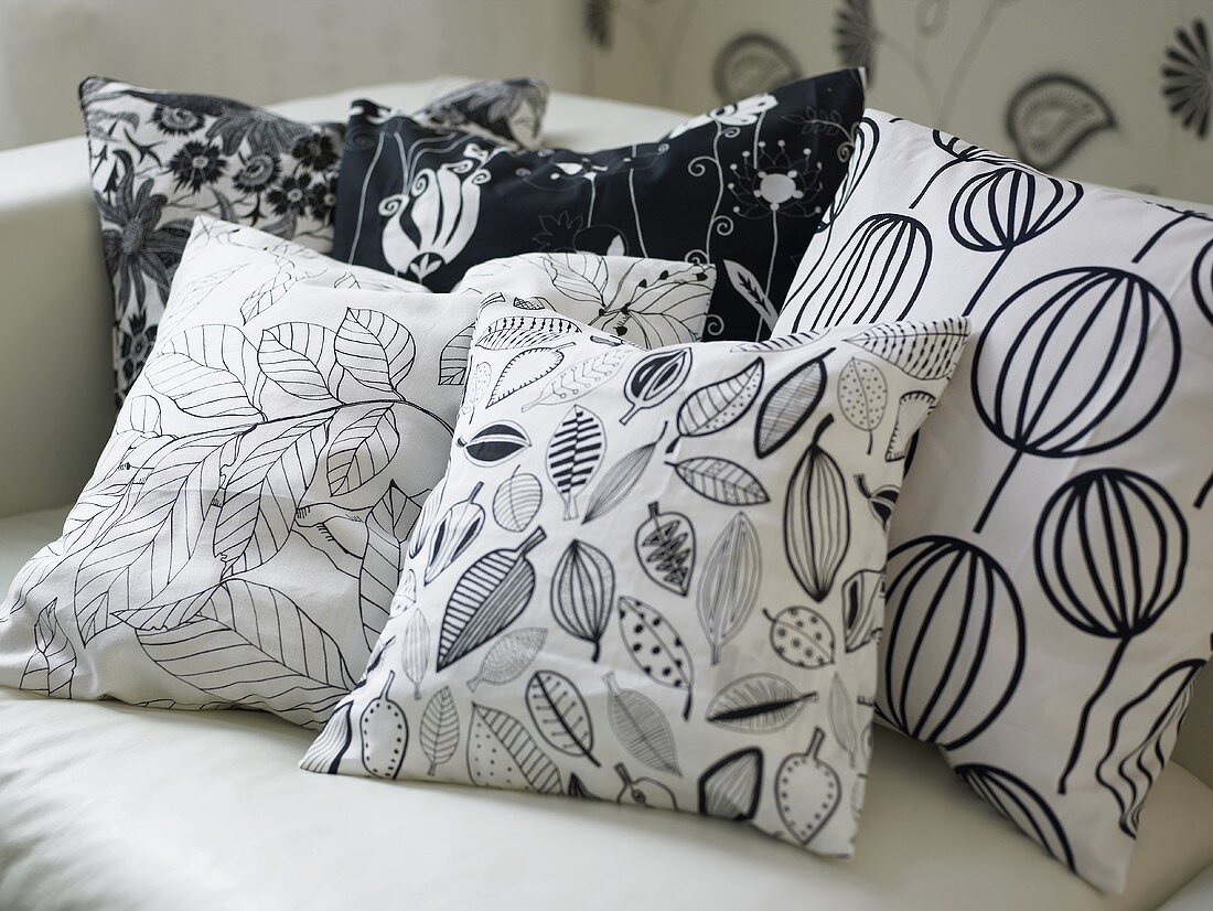 Various black and white patterned cushions on a sofa