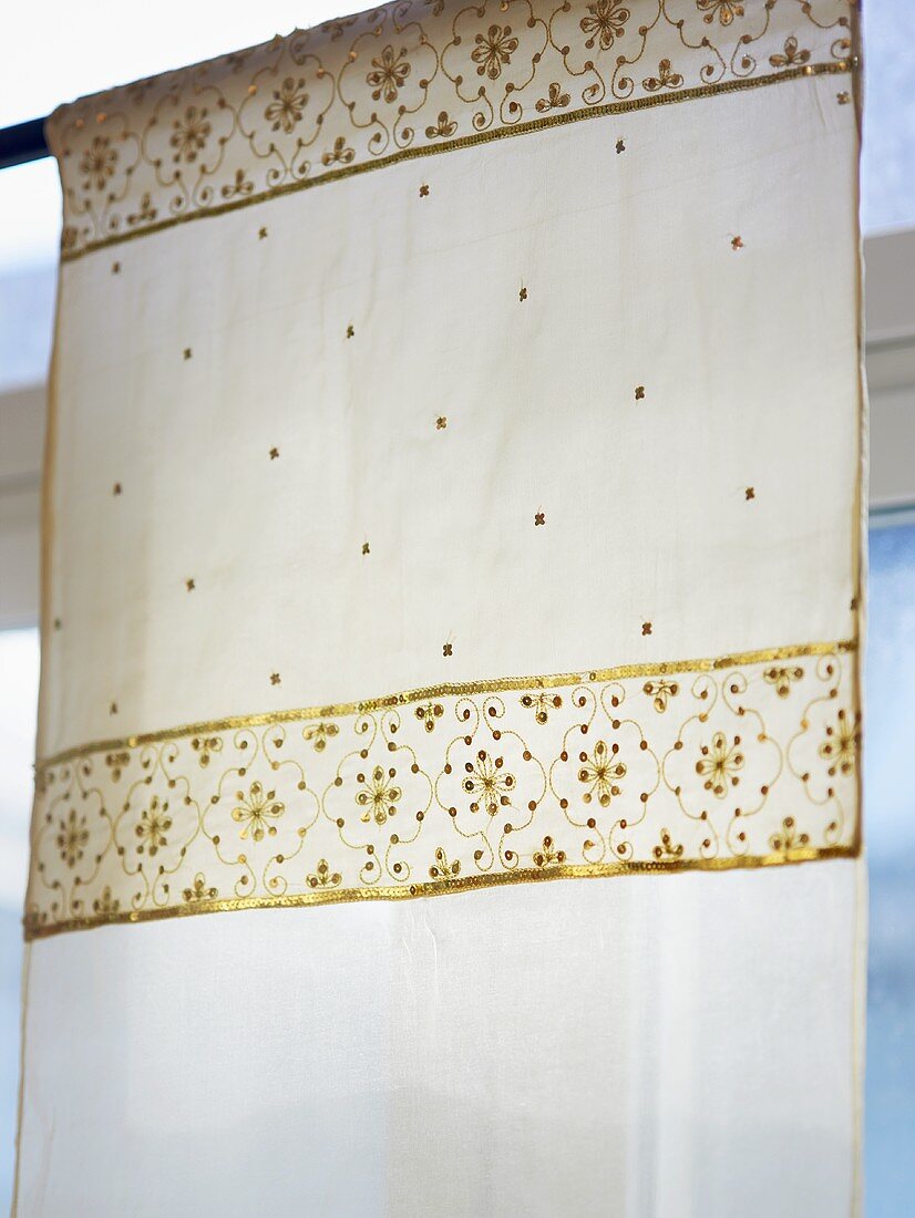 A curtain with gold embossing