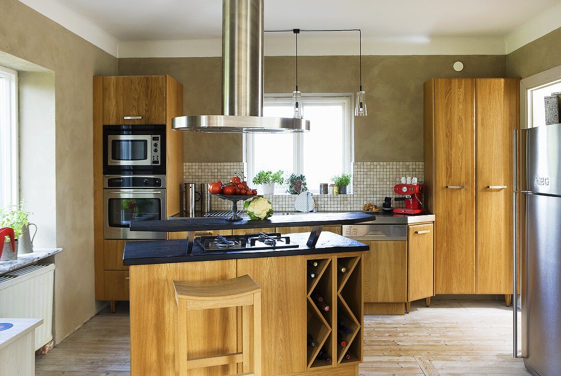 A kitchen counter in a fitted, open-plan kitchen with wooden cupboards
