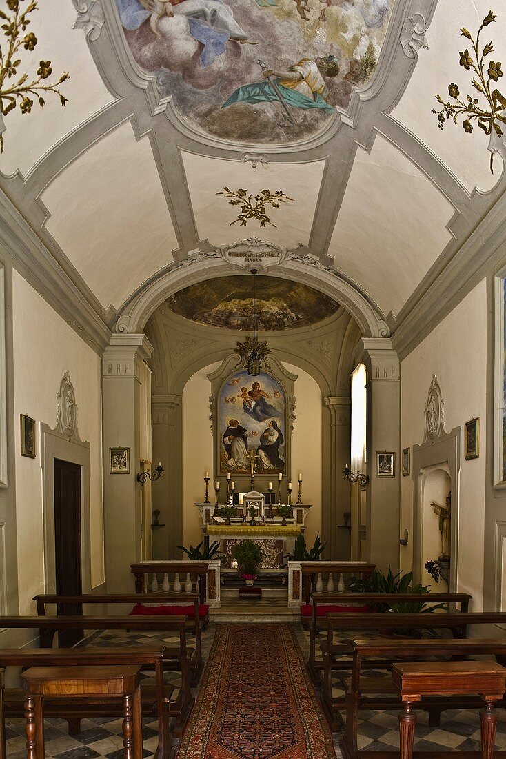View of the altar in a chapel with a ceiling fresco