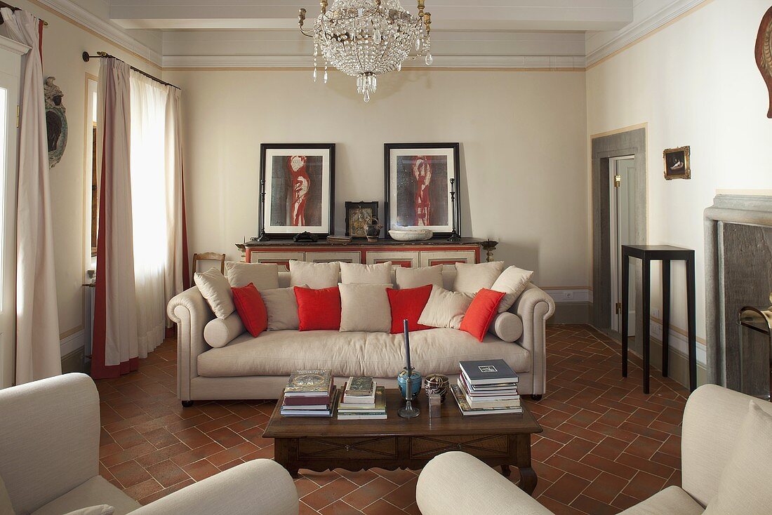 Elegant living room in a country home with light gray upholstered furniture on terracotta flooring