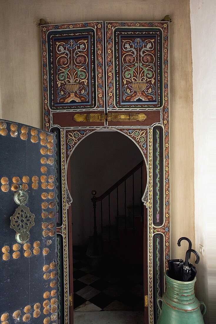 Oriental style painted door with a view of a stairway
