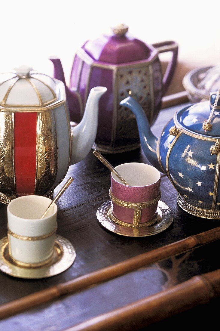 Moroccan tea pots and tea cups with spoons