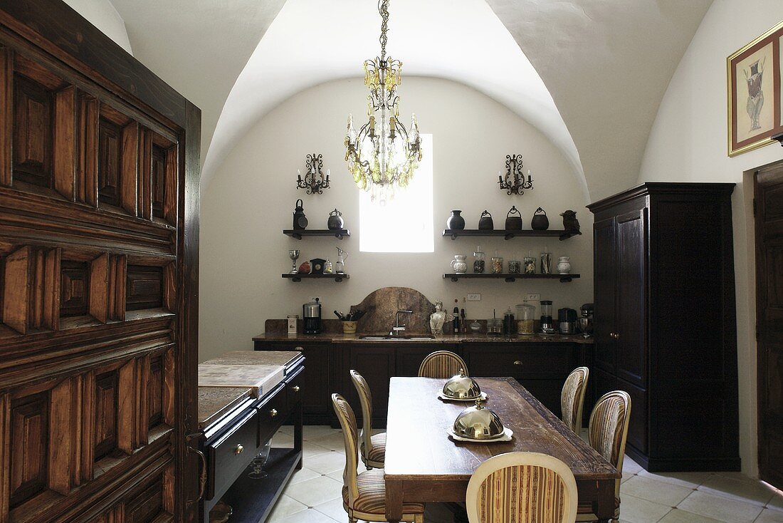 A vaulted ceiling in a dining room with dark wooden furniture