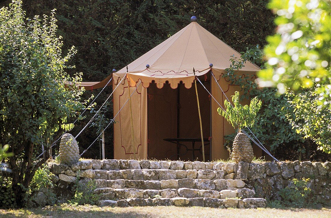 Tent on a garden terrace with natural stone steps