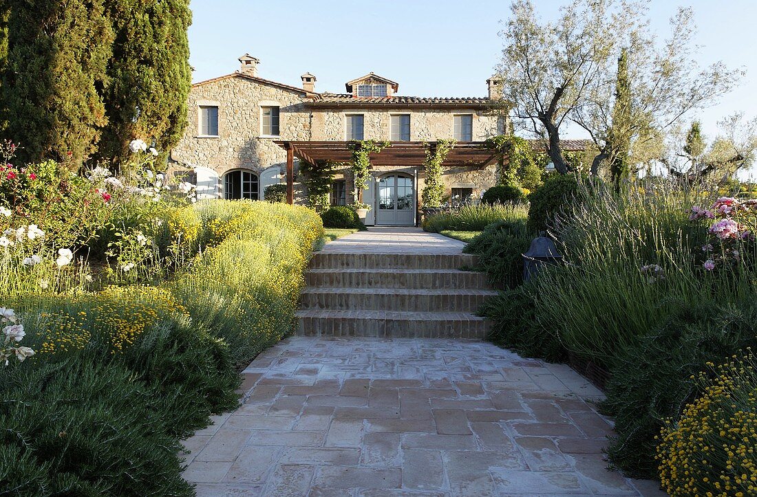 Private path with stairs through the front garden of a Mediterranean villa