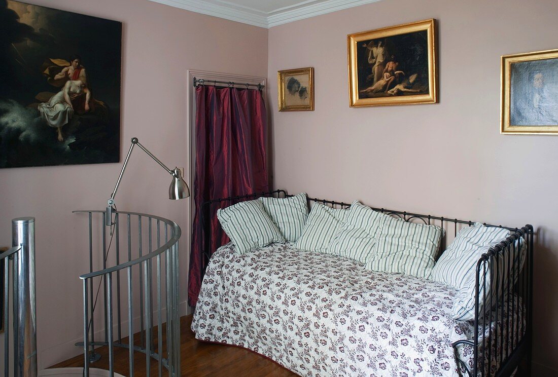 Metal bed in pink room and stainless steel stair railings