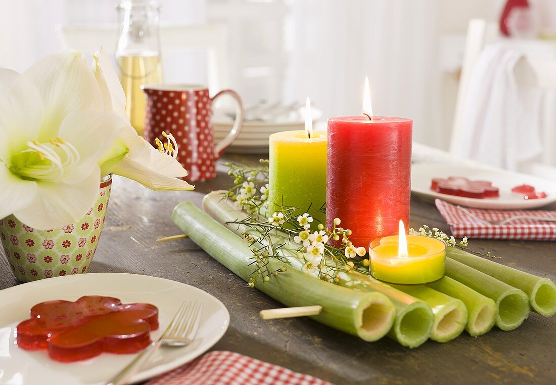 Table decoration on a laid table with coloured candles