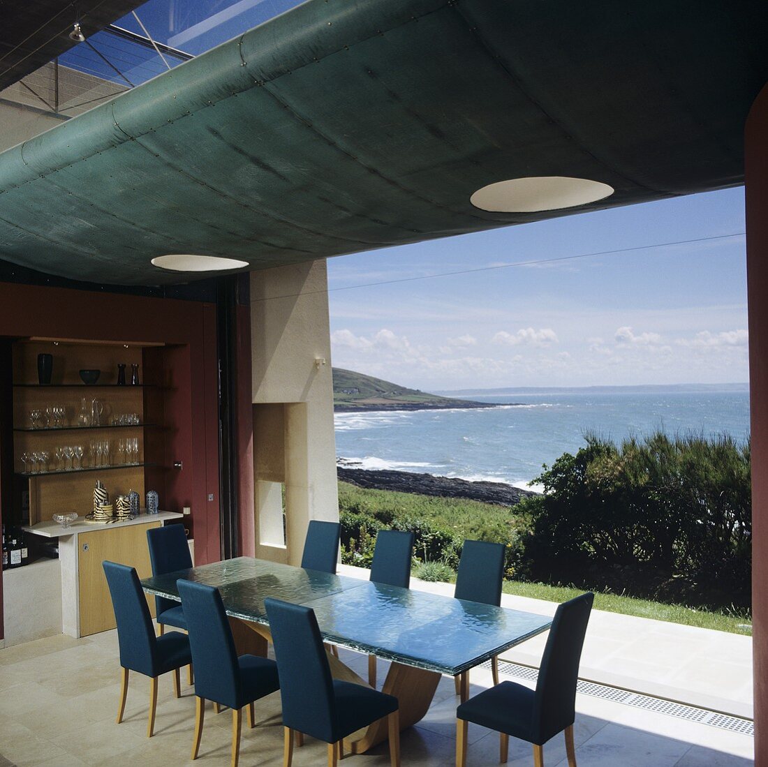 Dining area in front of a wall of window with a fantastic view of the ocean