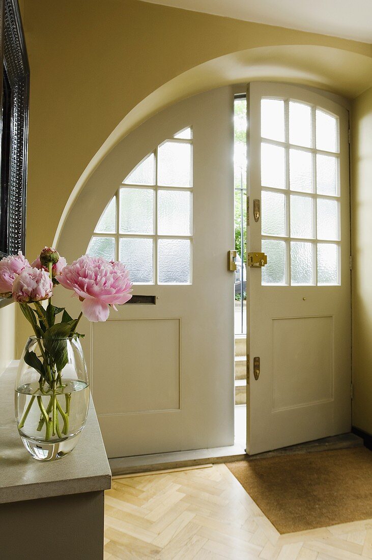 A hallway in a country house with an arched entrance way