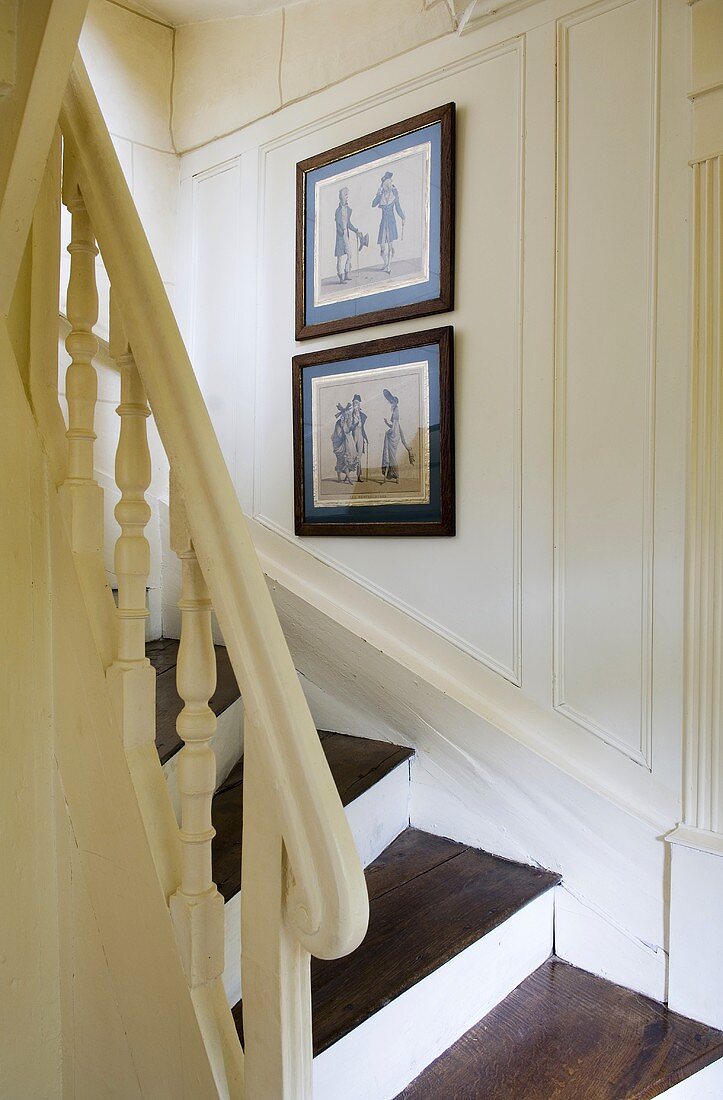 A white, wood panelled, country house-style stairway