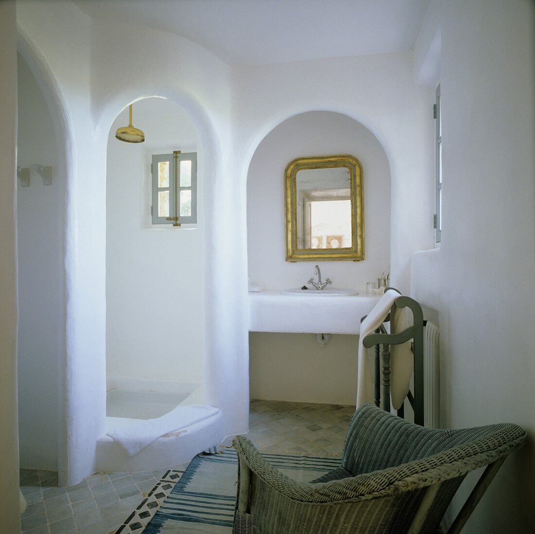 A Mediterranean bathroom with stone niches and archways