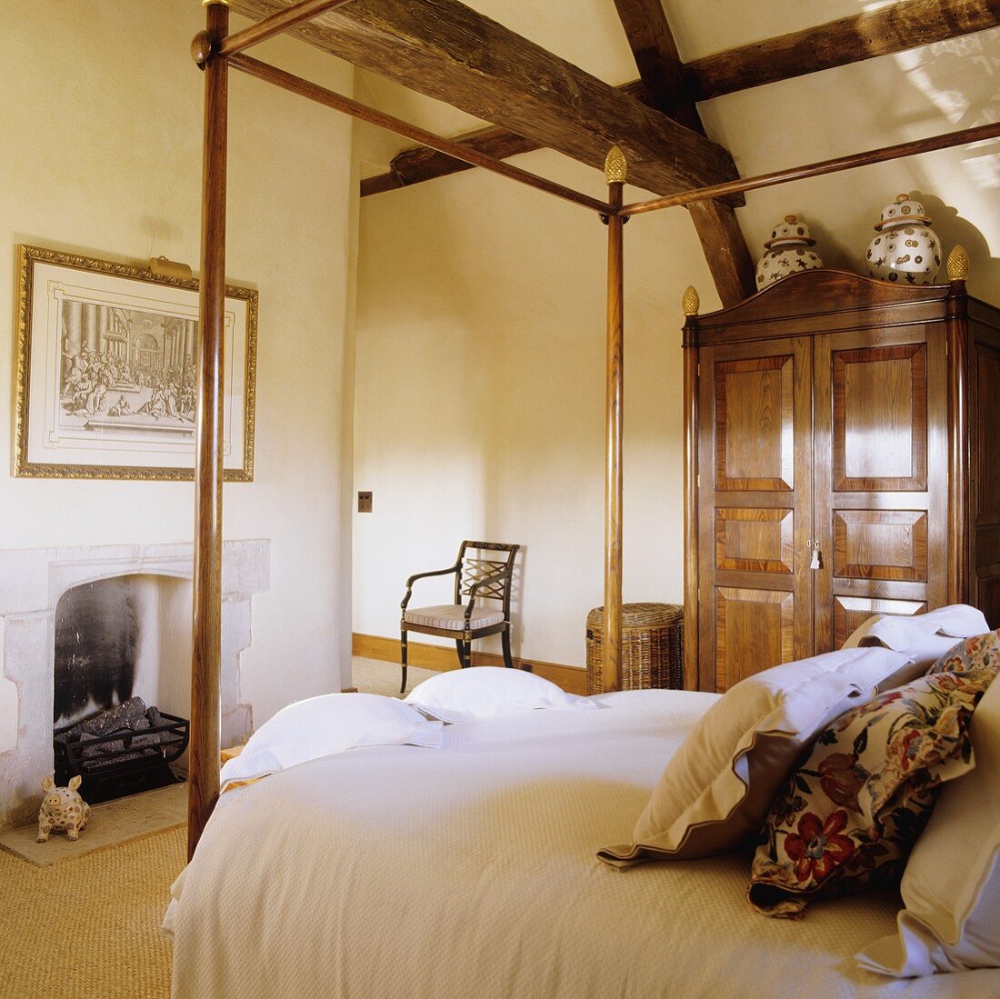A wooden four-poster bed and an antique wardrobe in a country house-style bedroom under a rustic wooden construction