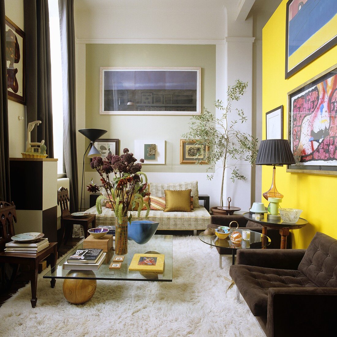 A high ceilinged, 70s-style living room with a flokati rug and a brown armchair in front of a yellow wall