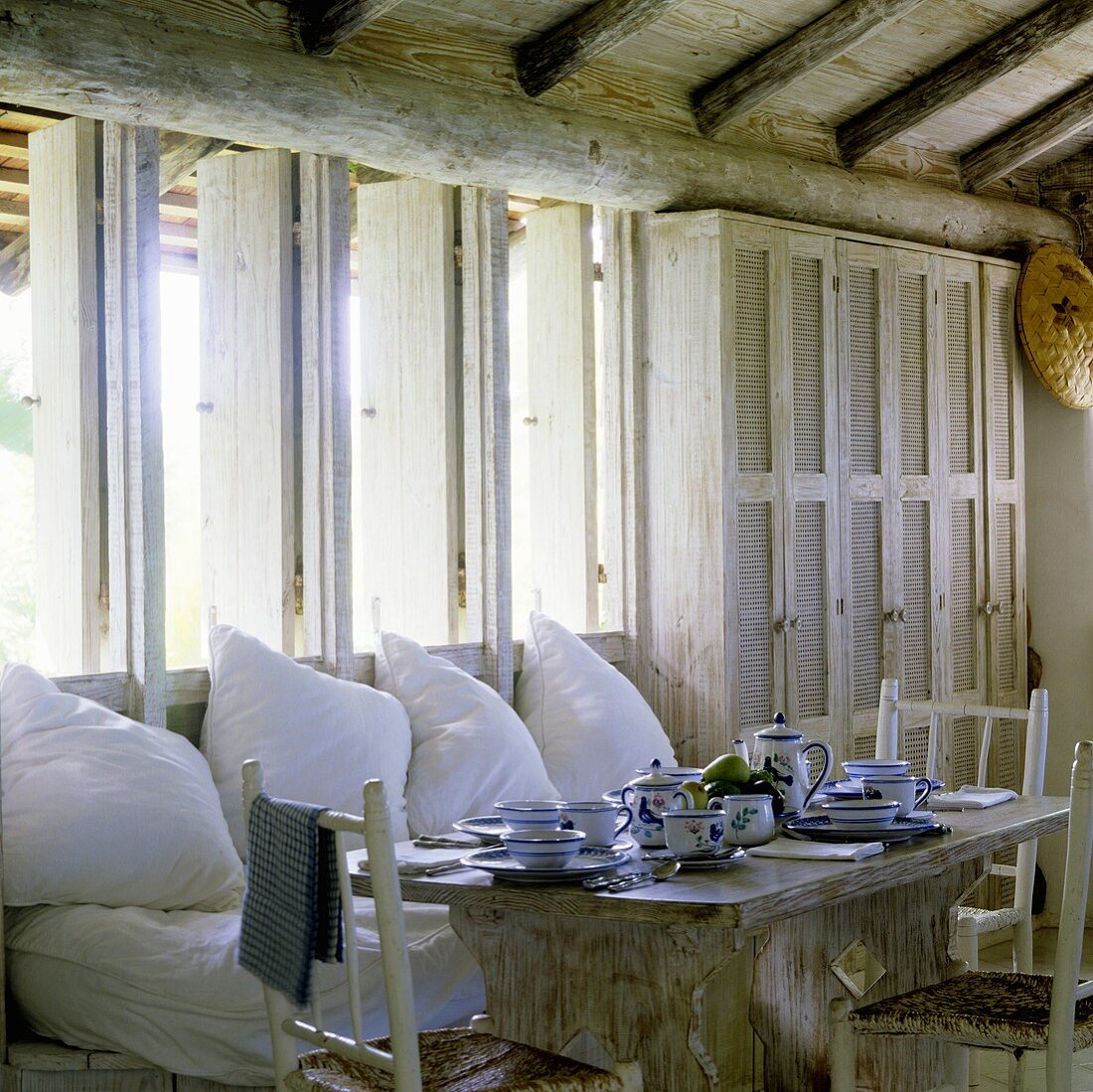 Breakfast in a tropical holiday home with a comfortable bench with white cushions