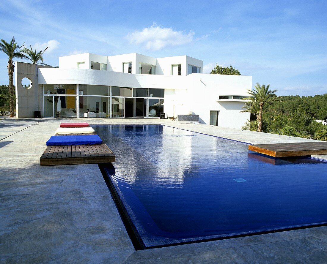 A blue sky above a Mediterranean luxury villa with a pool