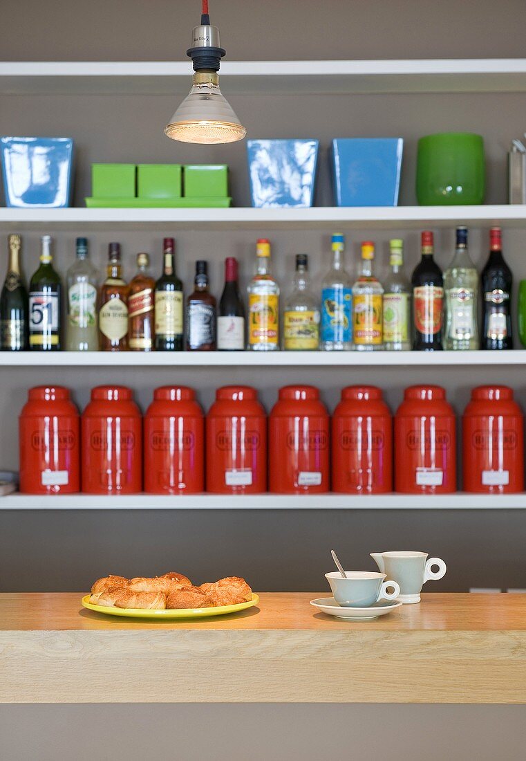 Breakfast at the bar - bottles of spirits and storages jars on the shelf
