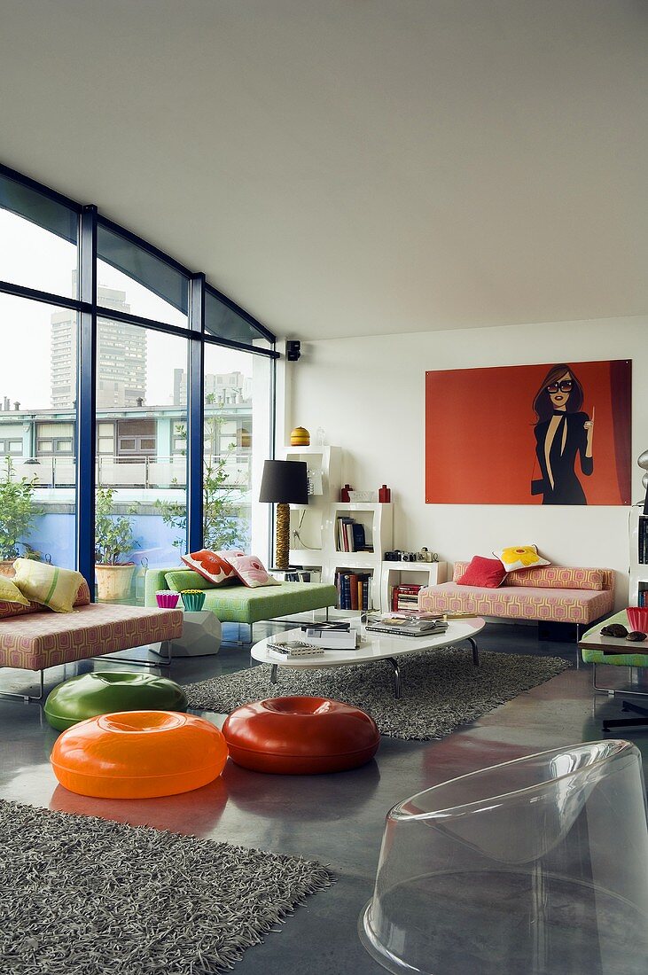 Colourful plastic floor furniture in a rooftop apartment with a wagon ceiling