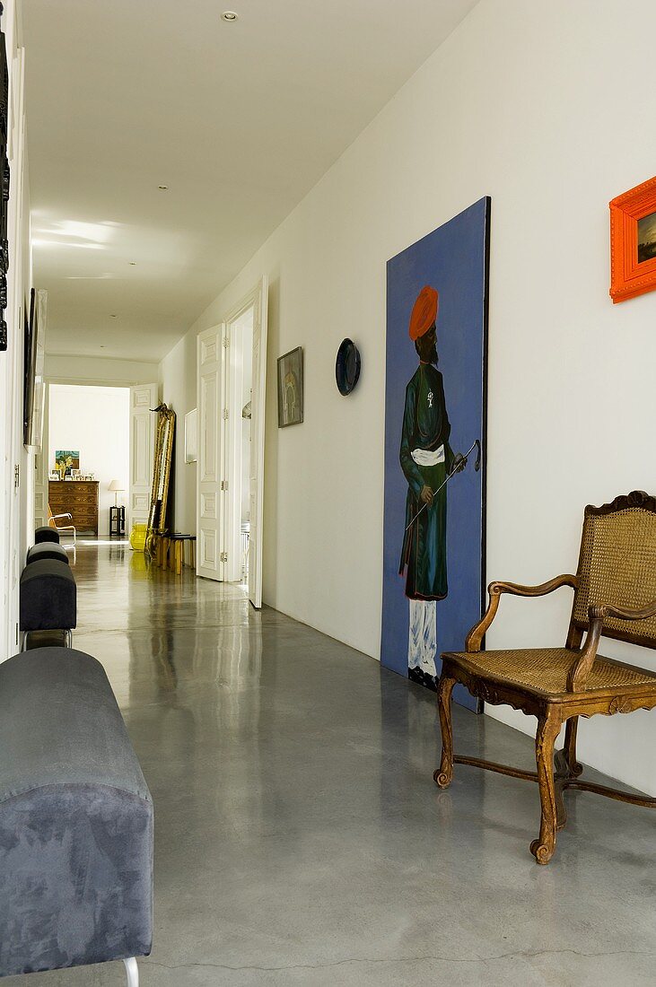 A minimalistic hallway with a reflective concrete floor