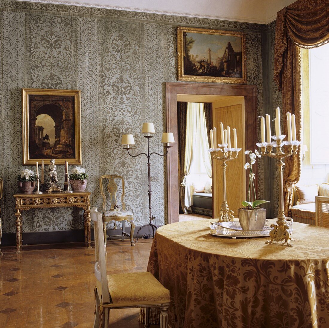 A dining room in a palazzo with Rococo furniture and an antique candlestick on the table