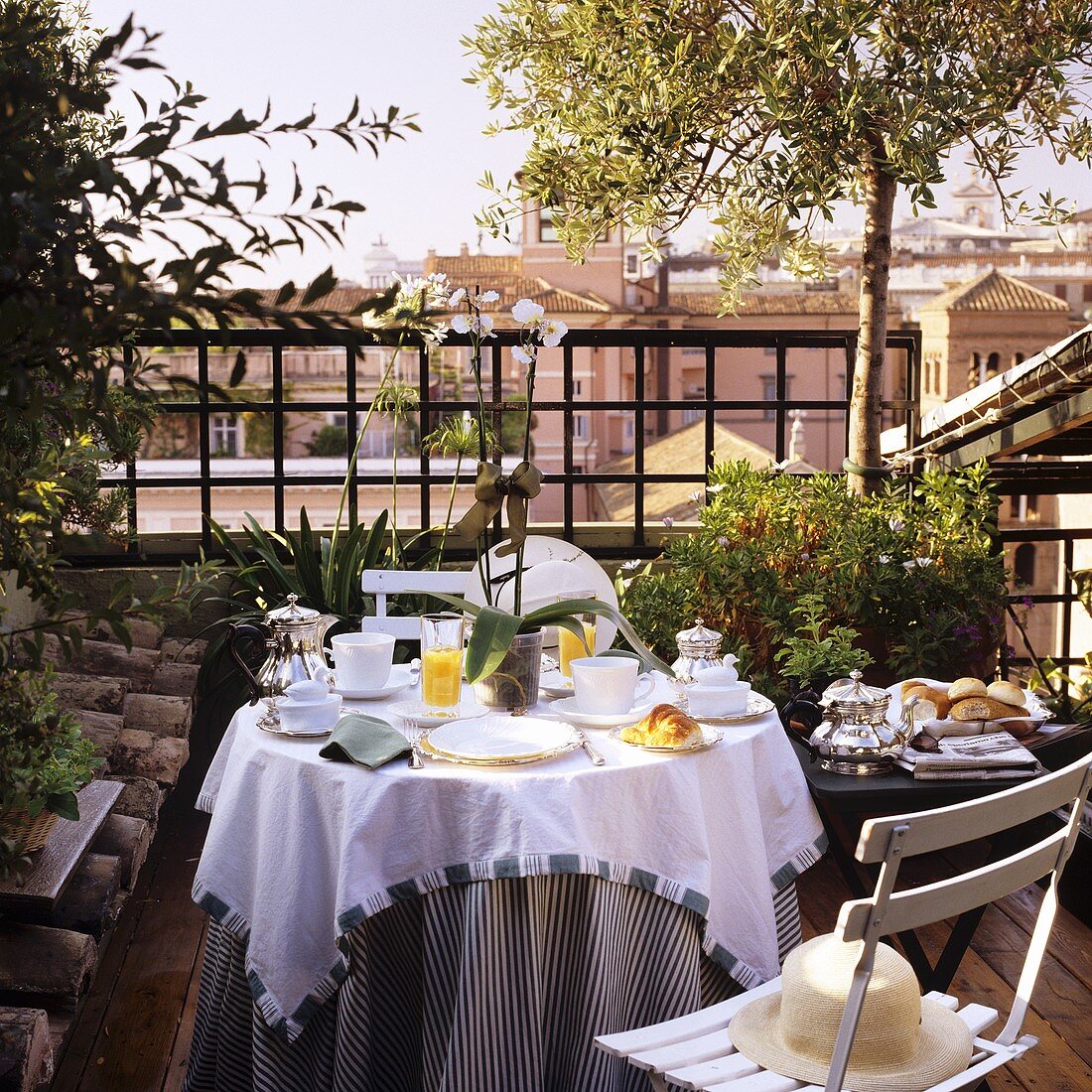 Breakfast outside - a table laid on a Southern roof terrace
