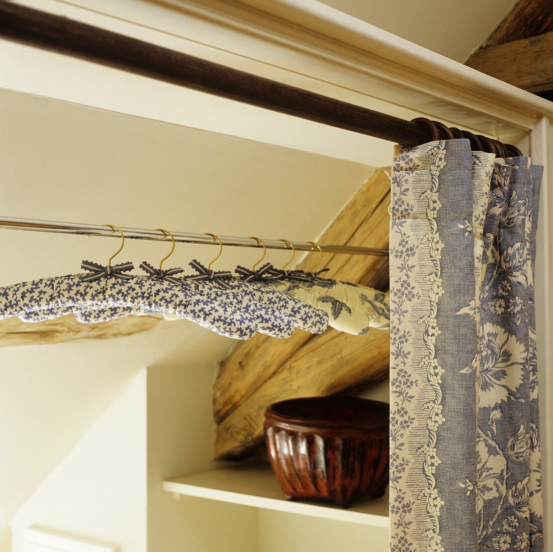 Fabric-covered hangers in a wardrobe