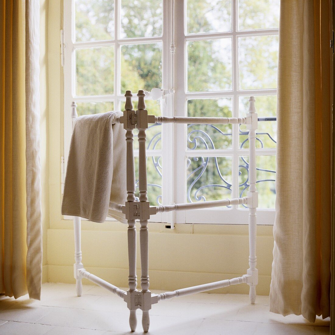A towel rack in front of a window in country house