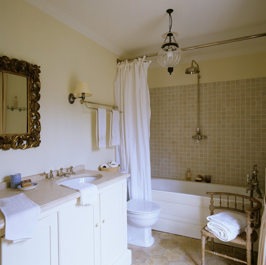 A bathroom in a country house with a marble-topped washstand an antique accessories