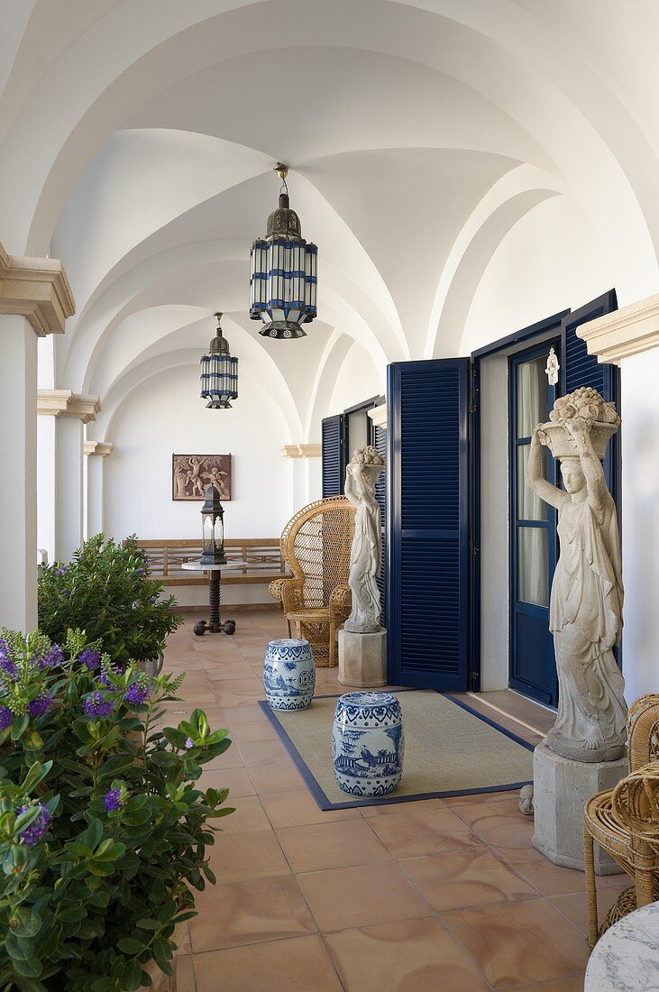 A Mediterranean house with an elegant terrace and lanterns hanging from the vaulted ceiling