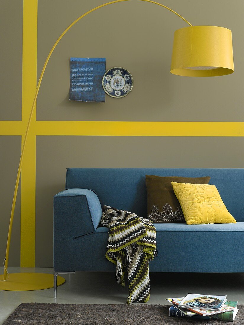 A yellow lamp and a blue sofa