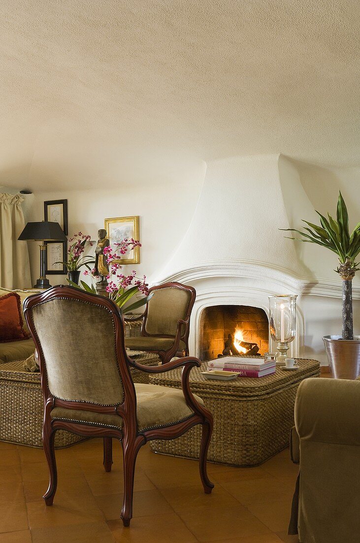 A relaxing setting in front of a fireplace in a Mediterranean lounge