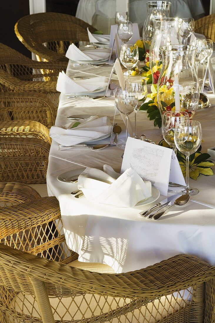 Wicker chairs around a festively laid table
